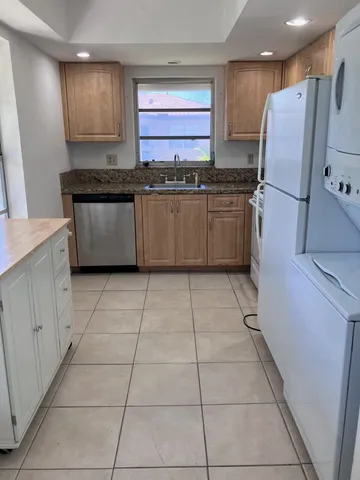 a kitchen with stainless steel appliances cabinets a sink and a counter top space