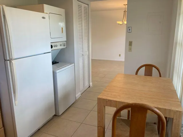 a kitchen with a refrigerator and a sink