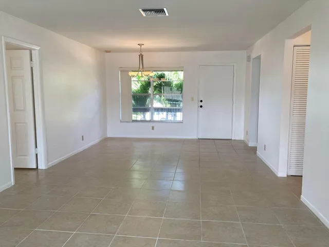 an empty room with a empty space and windows