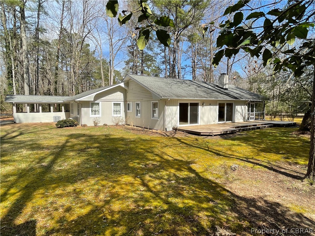 931 Laurel Point Road Lancaster, VA 22503 - Photo 6 of 21 a front view of a house with a garden
