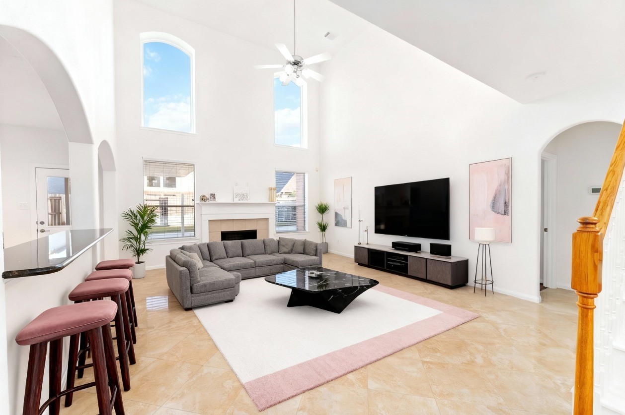 a living room with furniture a flat screen tv and a fireplace