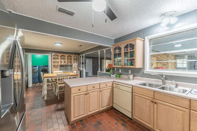 a kitchen with a sink stove and cabinets
