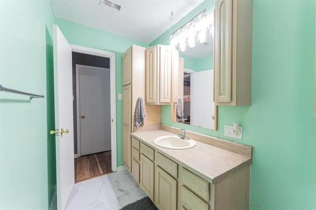 a bathroom with a sink a mirror and a bathtub