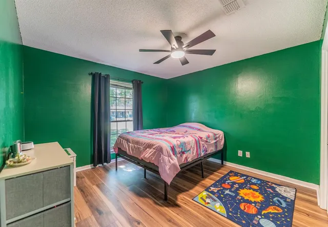 a bedroom with a bed and a dresser