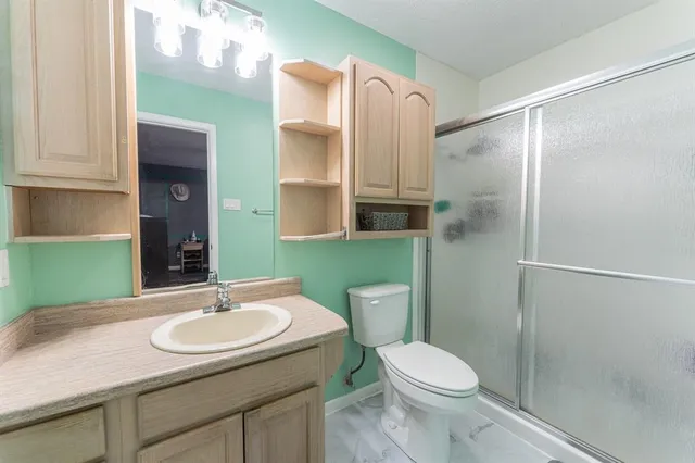 a bathroom with a sink toilet and shower