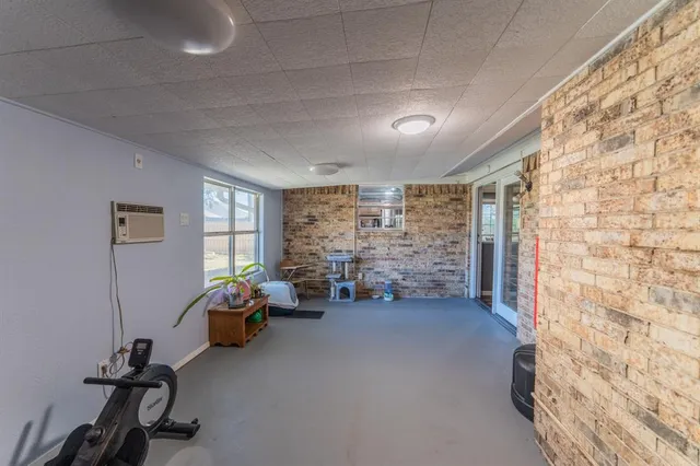 a view of a livingroom with workspace and a window