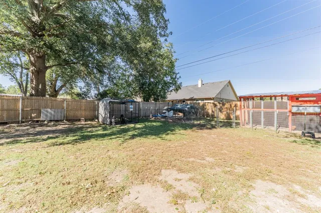 a view of a house with a yard and tree