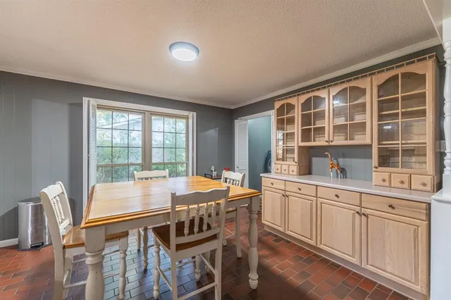 a dining room with furniture window and wooden floor