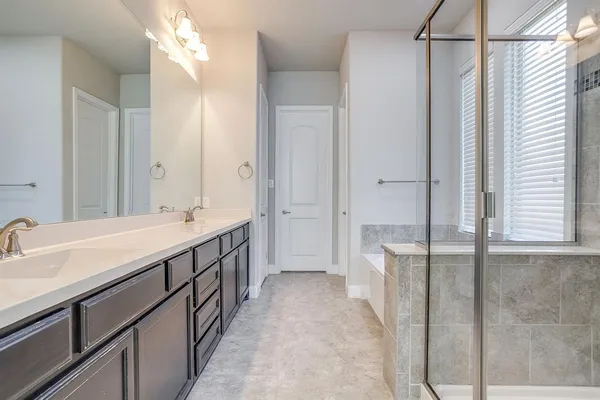 a bathroom with a double vanity sink and mirror