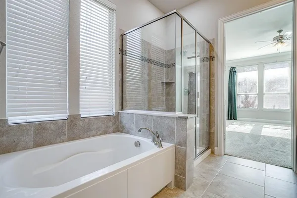 a bathroom with a bathtub and a shower