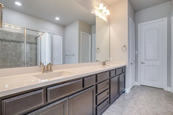 a spacious bathroom with a double vanity sink mirror and double