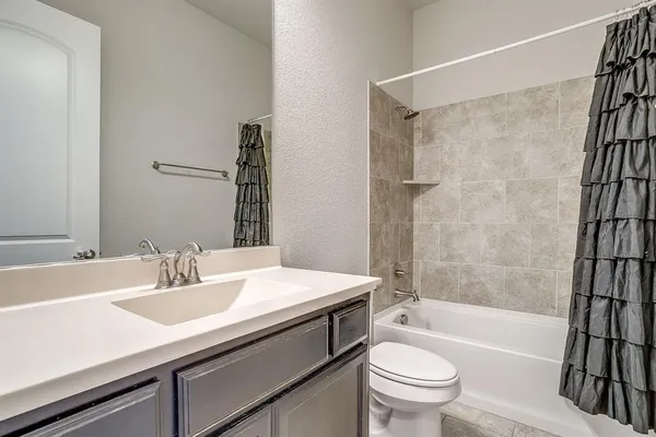 a bathroom with a sink a toilet and a bathtub