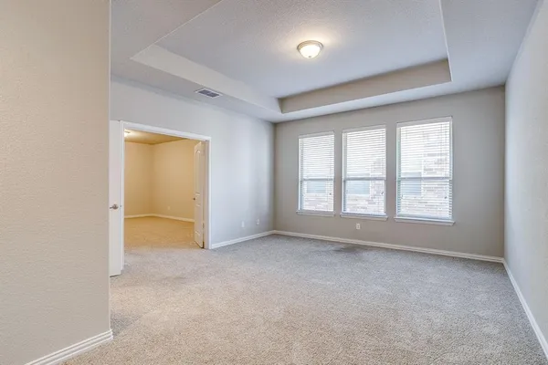 an empty room with a empty space and windows