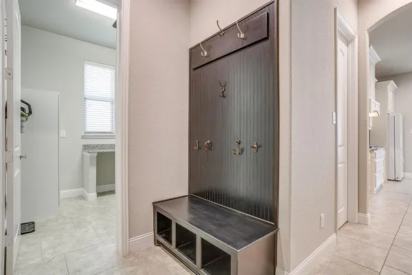 a view of bathroom with sink mirror and shower