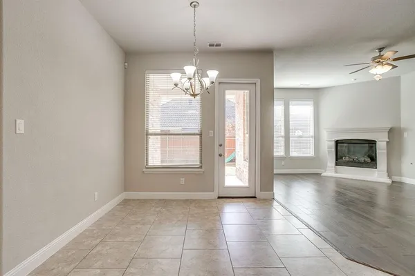 a view of livingroom with chandelier fan and fire place