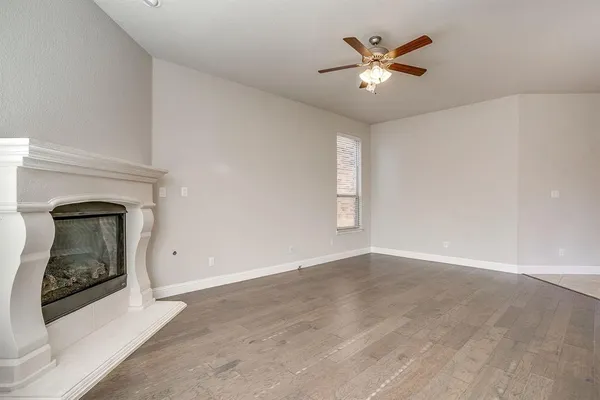 an empty room with closet and a chandelier fan