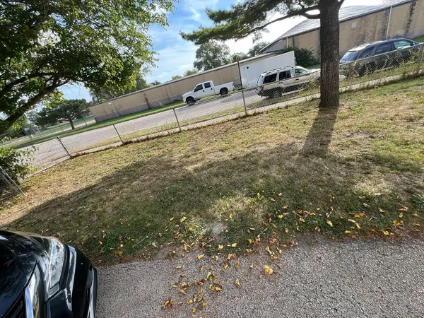 a view of building with car parked