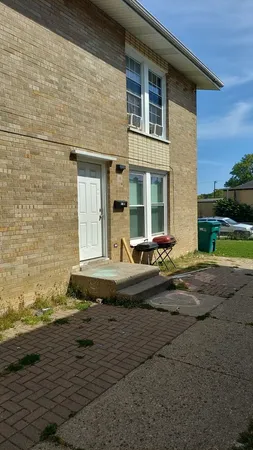a street view with residential house and car parked