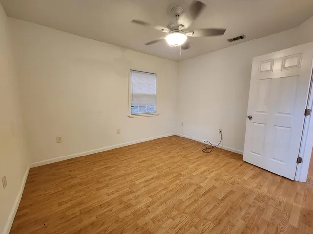 a view of empty room with a fan