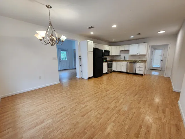 a view of a kitchen with a sink and cabinet area