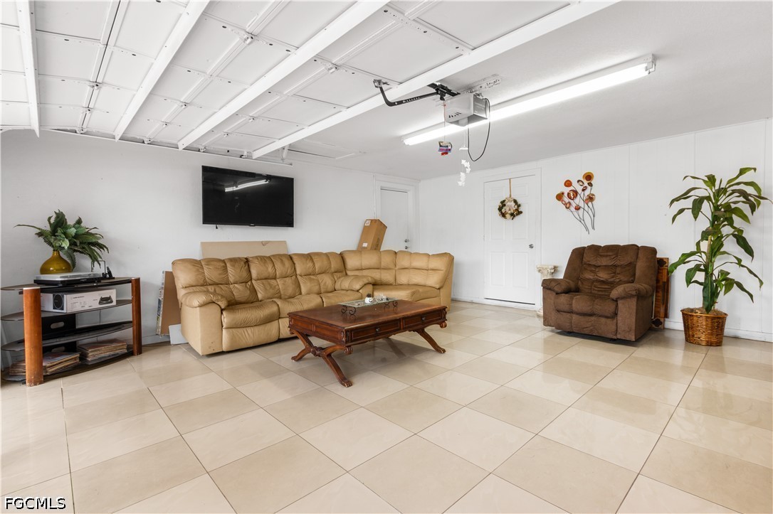 18 Illinois Road Lehigh Acres, FL 33936 - Photo 28 of 45 a living room with furniture and a flat screen tv