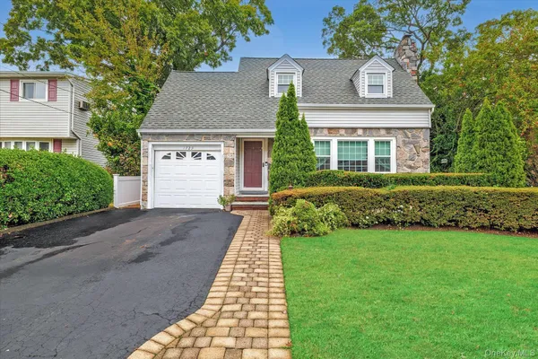 front view of a house next to a yard