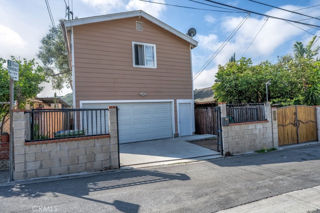 6834 Quinton Lane Tujunga, CA 91042 - Photo 1 of 22 a view of a small house and wooden fence