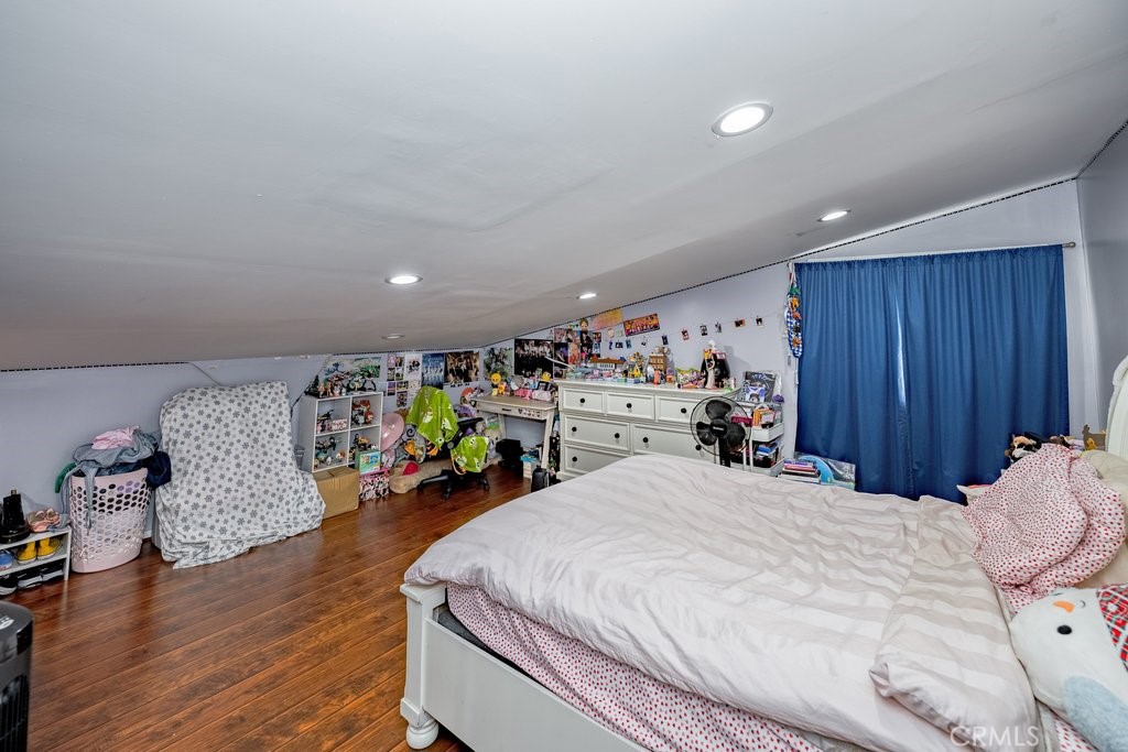 6834 Quinton Lane Tujunga, CA 91042 - Photo 13 of 22 a bedroom with a bed and a wooden floor