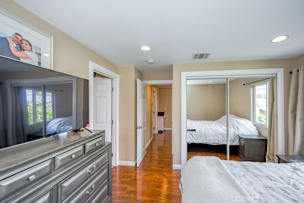 6834 Quinton Lane Tujunga, CA 91042 - Photo 16 of 22 a bedroom with bed and wooden floor