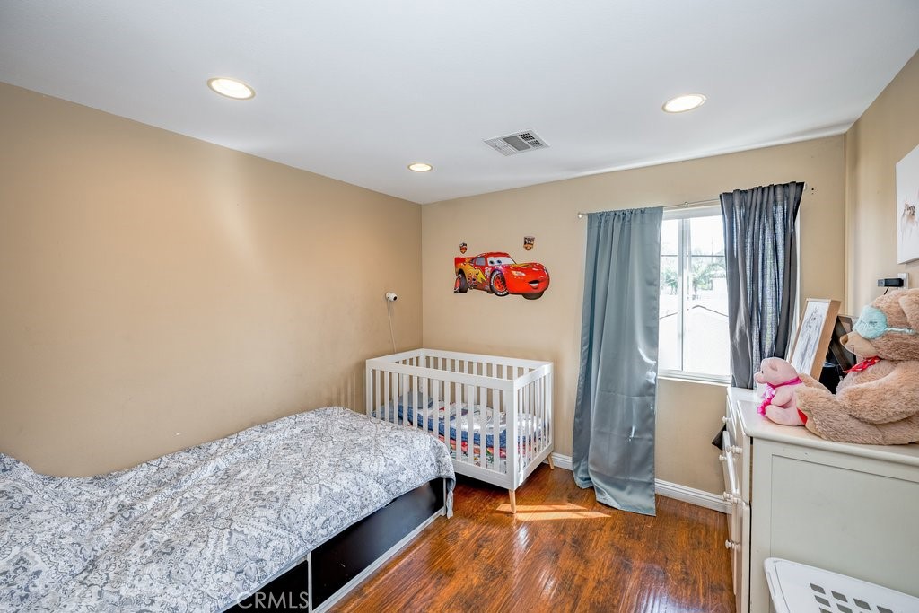 6834 Quinton Lane Tujunga, CA 91042 - Photo 10 of 22 a bedroom with a bed and wooden floor