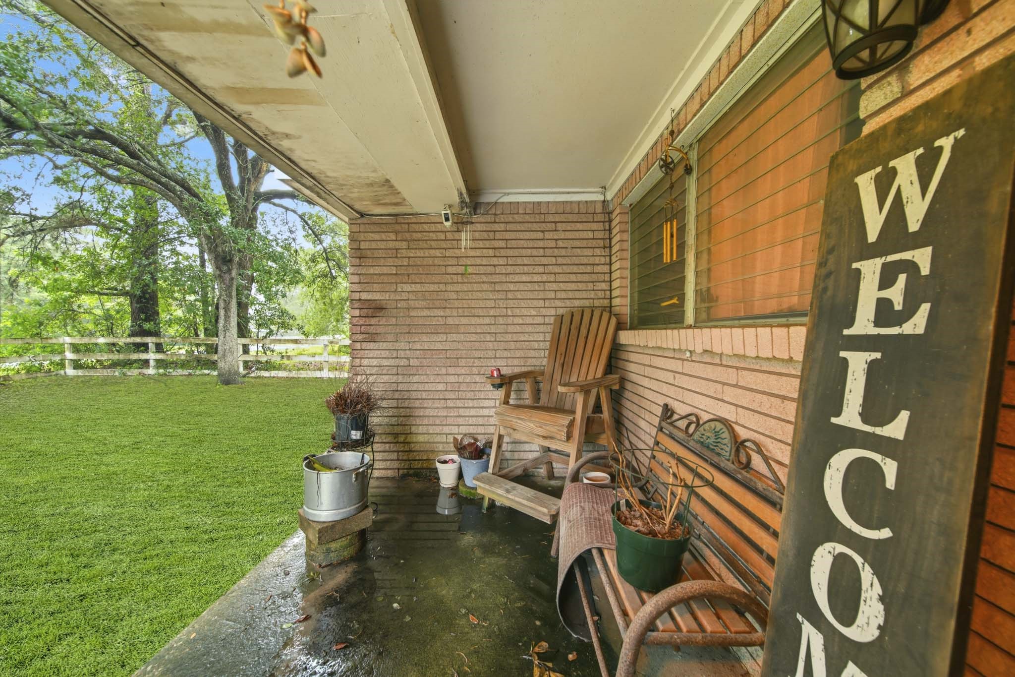 731 Meneley Road Winnie, TX 77665 - Photo 2 of 27 a view of a patio with chairs and garden