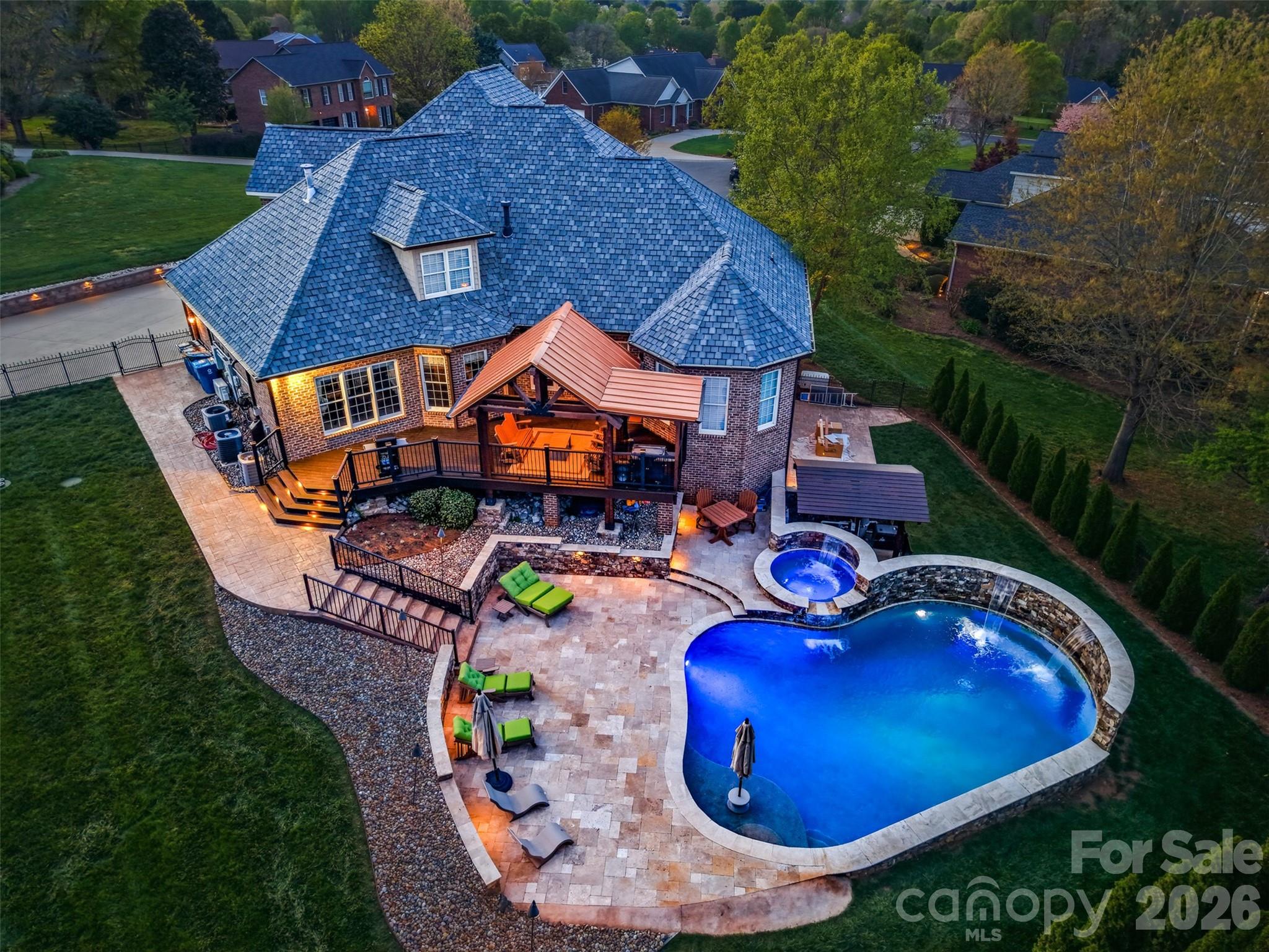 an aerial view of a house with swimming pool garden and outdoor seating