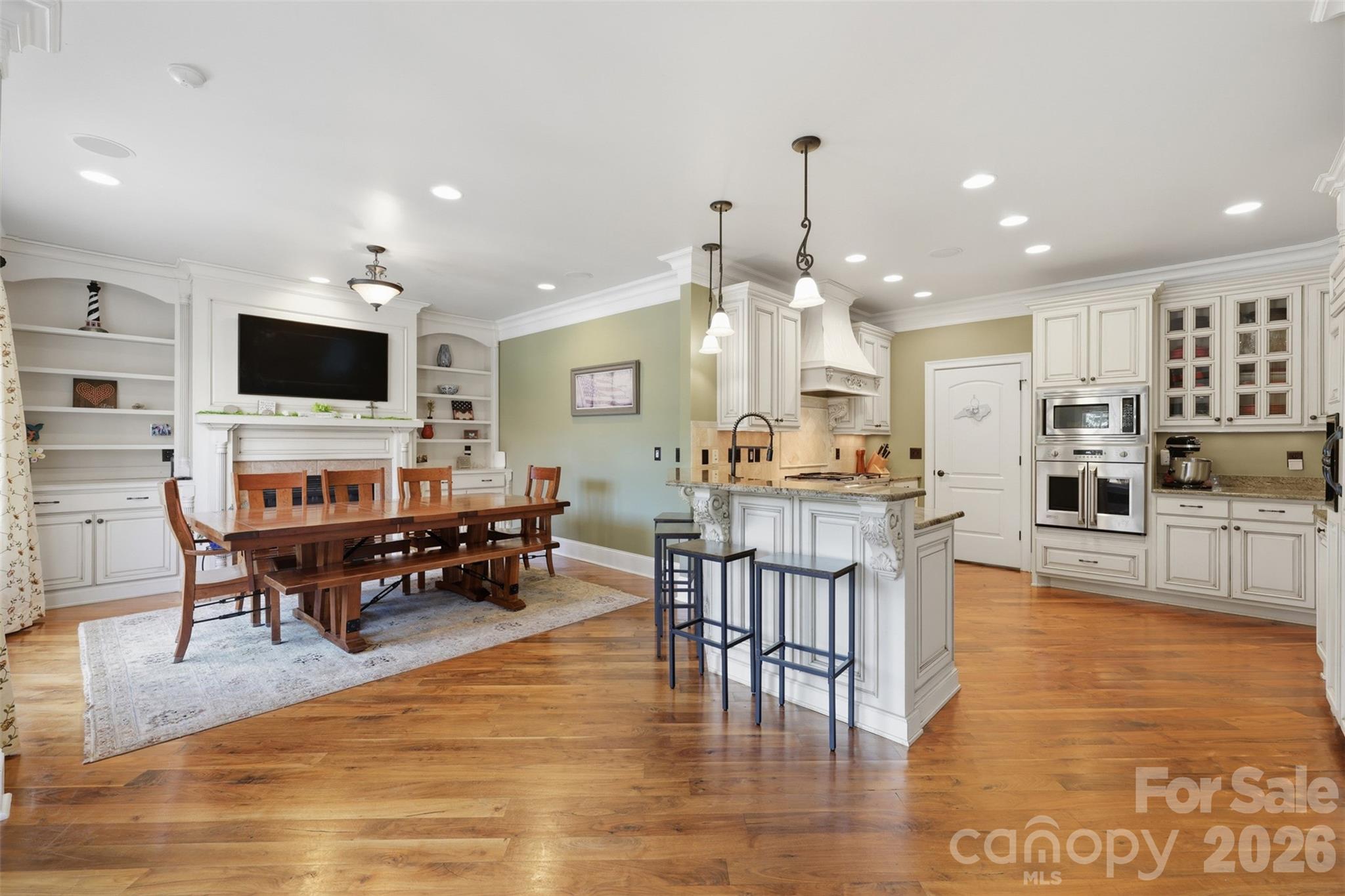 3638 Hogan Court Conover, NC 28613 - Photo 11 of 38 a living room with fireplace furniture and a dining table with wooden floor