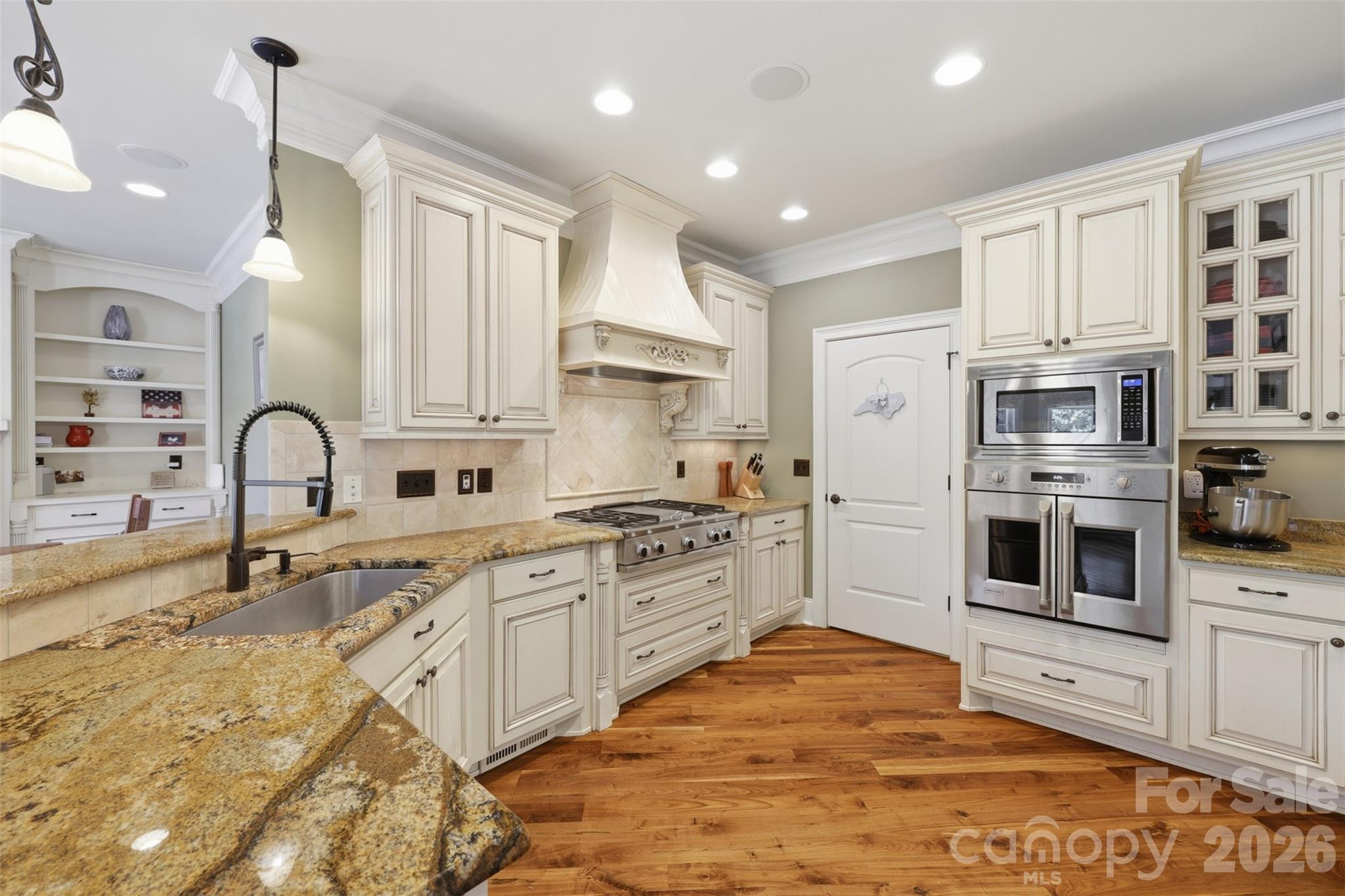 3638 Hogan Court Conover, NC 28613 - Photo 12 of 38 a large white kitchen with stainless steel appliances granite countertop a stove and a sink