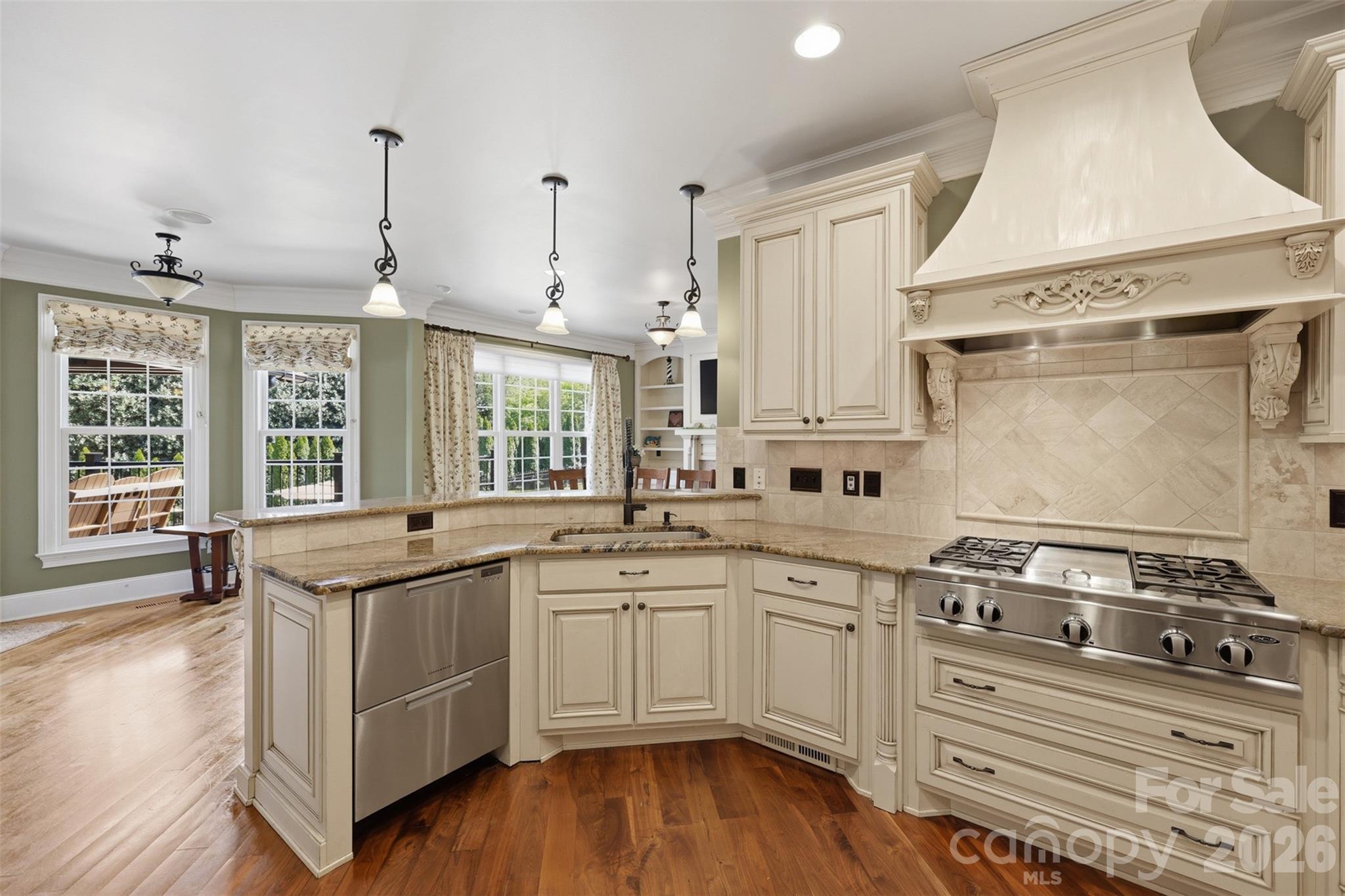 3638 Hogan Court Conover, NC 28613 - Photo 13 of 38 a kitchen with a stove a sink and white cabinets with wooden floor