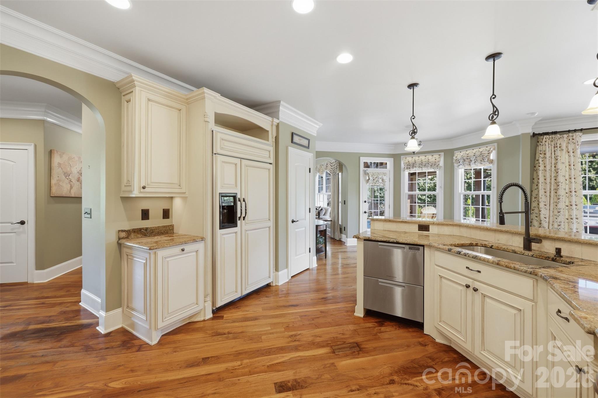 3638 Hogan Court Conover, NC 28613 - Photo 14 of 38 a kitchen with stainless steel appliances granite countertop a refrigerator a sink dishwasher a stove and white cabinets with wooden floor