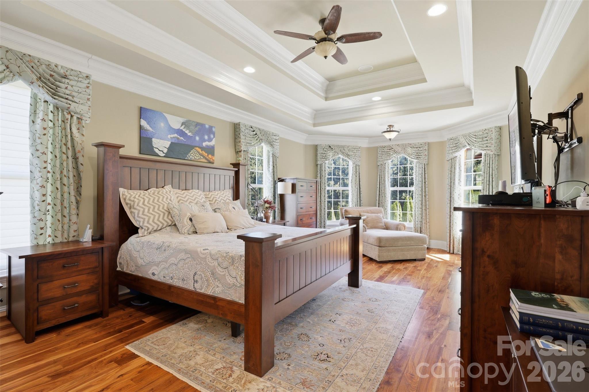 3638 Hogan Court Conover, NC 28613 - Photo 18 of 38 a spacious bedroom with a bed a couch and a chandelier