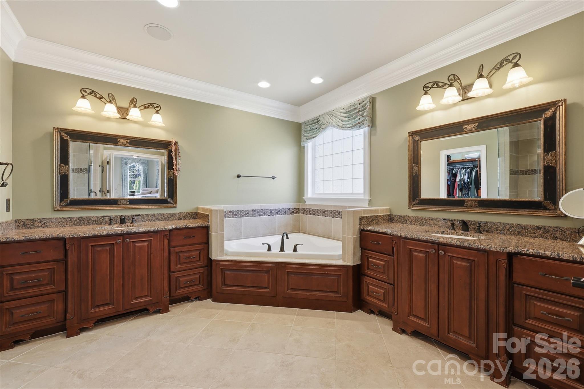 3638 Hogan Court Conover, NC 28613 - Photo 19 of 38 a bathroom with a tub double vanity sink and a large mirror