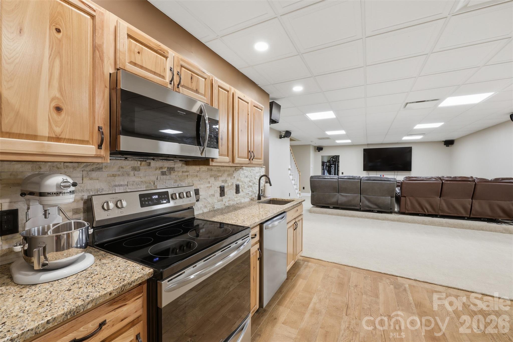 3638 Hogan Court Conover, NC 28613 - Photo 30 of 38 a large kitchen with stainless steel appliances granite countertop a stove a sink and a microwave