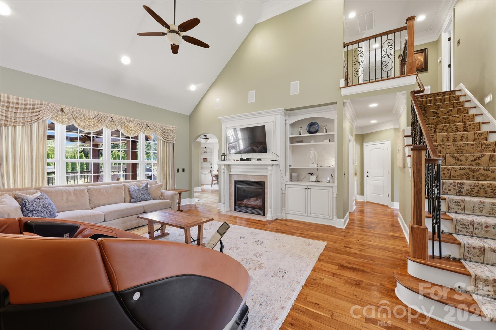3638 Hogan Court Conover, NC 28613 - Photo 10 of 38 a living room with furniture a fireplace and a flat screen tv