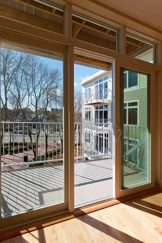 a view of a balcony with wooden floor and fence