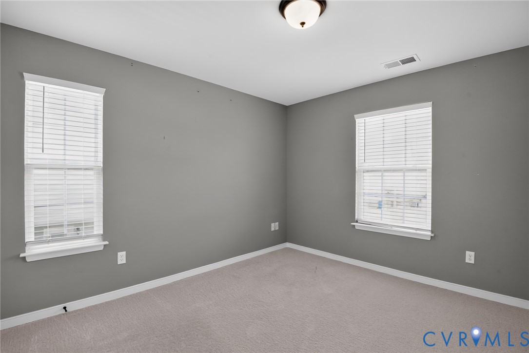 7825 Old Guild Road Richmond, VA 23237 - Photo 29 of 35 Light gray carpeted room with neutral gray walls
