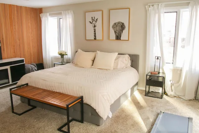 a bedroom with a bed and a window