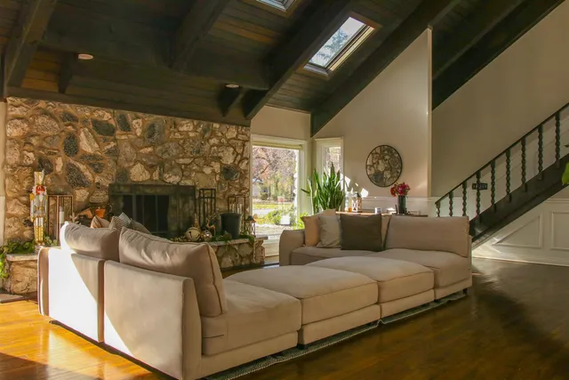 a living room with furniture a flat screen tv and a fireplace