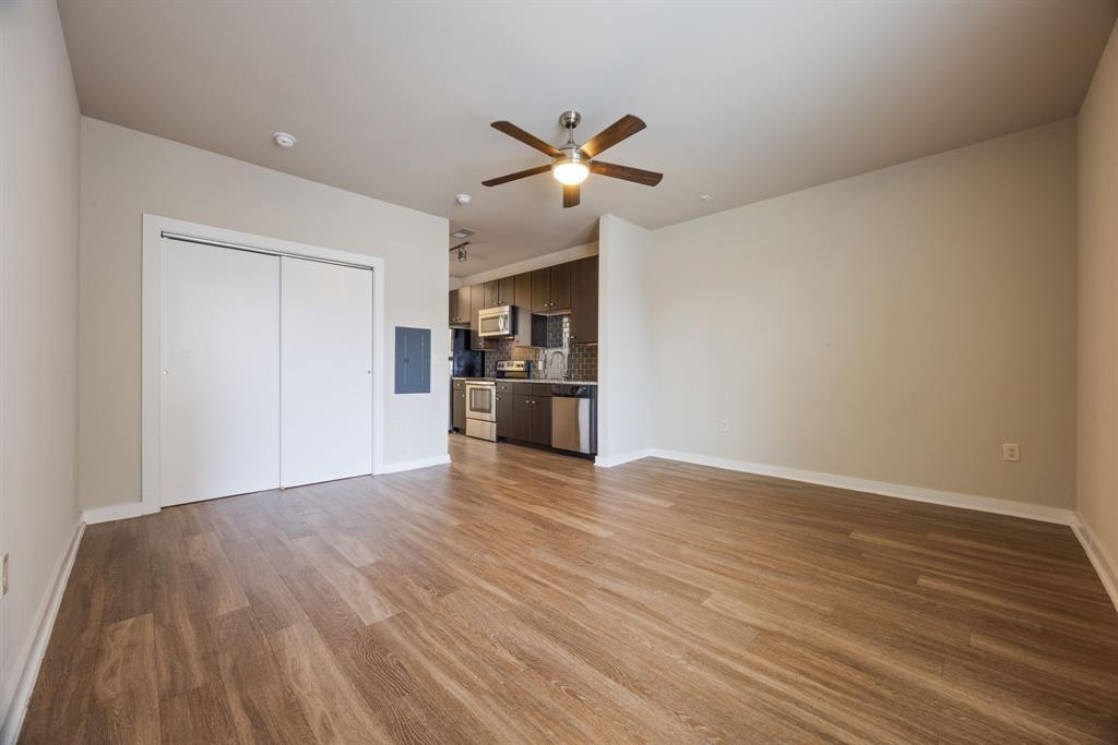 1900 Barton Springs Road, Unit 3013 Austin, TX 78704 - Photo 12 of 27 An open concept living area features resilient plank flooring and a stylishly equipped kitchen.