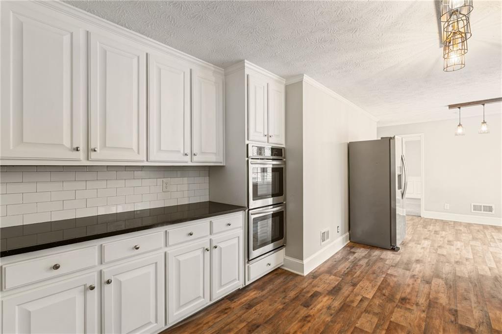 835 Lockriver Way Lawrenceville, GA 30044 - Photo 12 of 68 a kitchen with stainless steel appliances granite countertop a refrigerator and a sink
