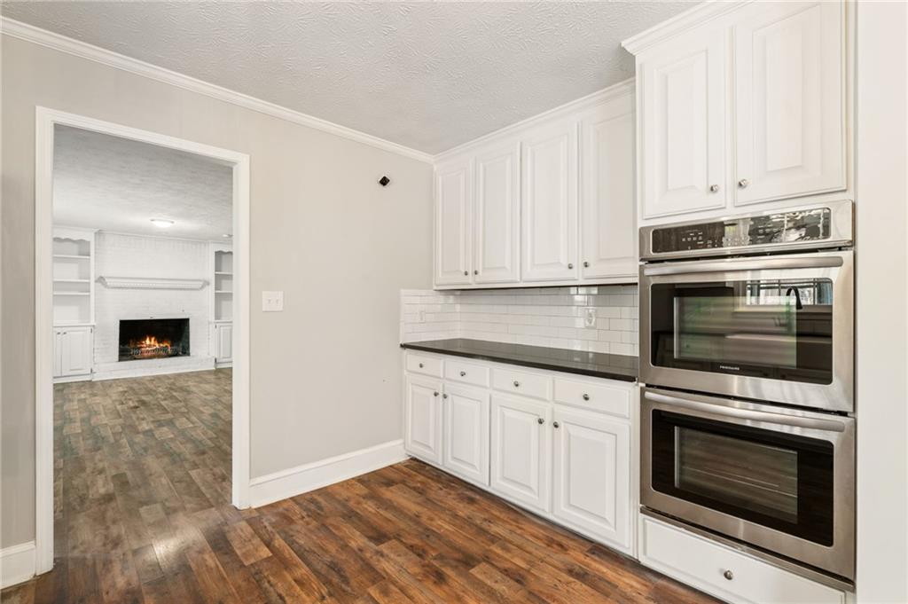 835 Lockriver Way Lawrenceville, GA 30044 - Photo 14 of 68 a kitchen with granite countertop white cabinets stainless steel appliances and sink