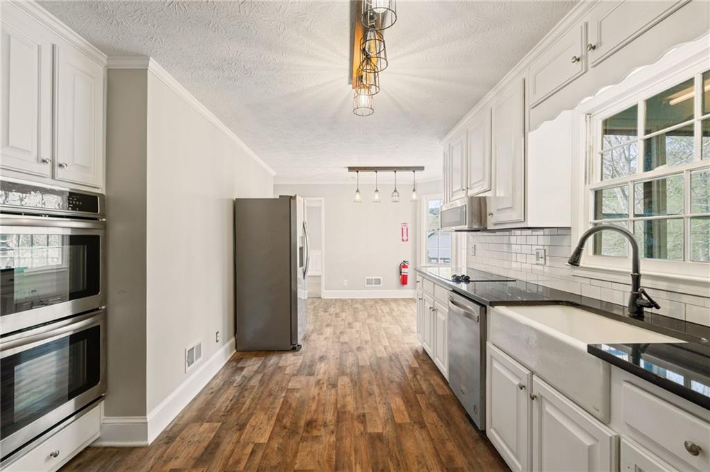 835 Lockriver Way Lawrenceville, GA 30044 - Photo 15 of 68 a kitchen with a sink stove and refrigerator