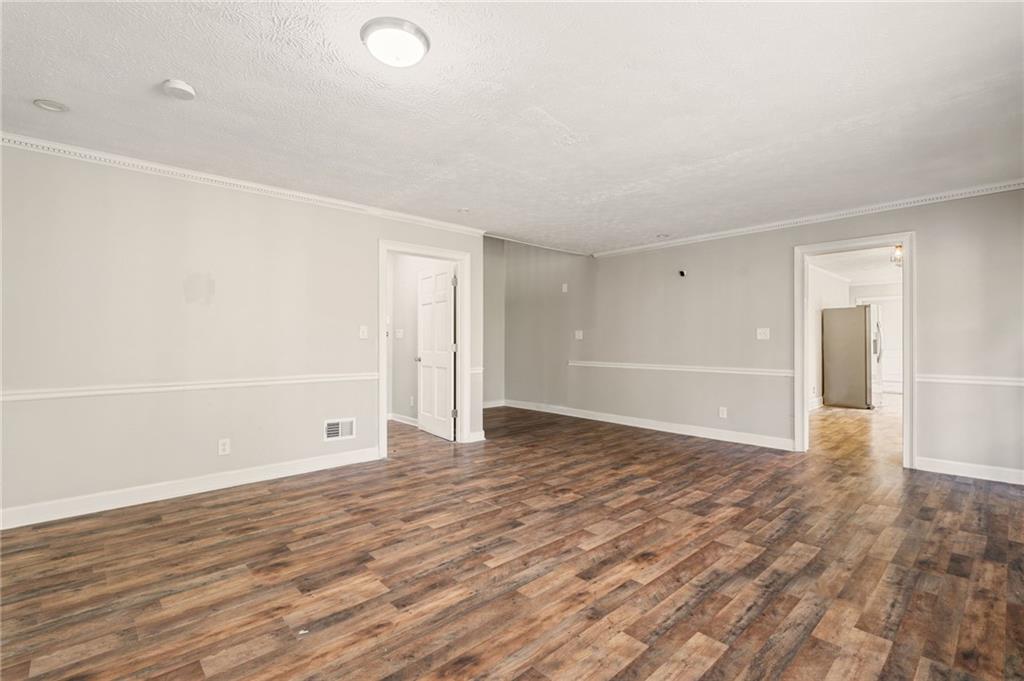 835 Lockriver Way Lawrenceville, GA 30044 - Photo 17 of 68 a view of an empty room with wooden floor and a window