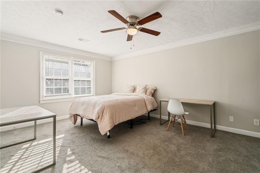 835 Lockriver Way Lawrenceville, GA 30044 - Photo 20 of 68 a bedroom with a bed and a chair